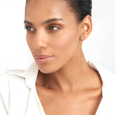 14k Yellow Gold Enamel Cross Stud Earrings on woman's ear
